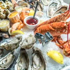 Un vassoio di frutti di mare su ghiaccio, con ostriche, gamberi, aragosta e cozze. Potrebbe scatenare la paura irrazionale di crostacei e molluschi in qualcuno.