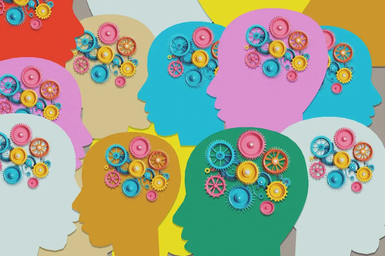 Ingranaggi colorati dentro profili di teste, simboleggiano la ruminazione mentale e il pensiero incessante.